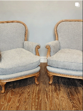 Dos sillones de madera tapizados en gris claro